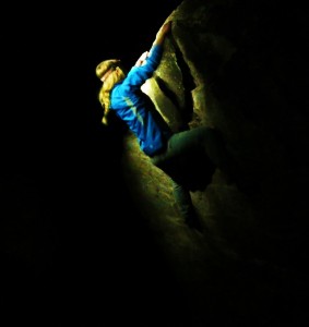 A climber boulders in the night