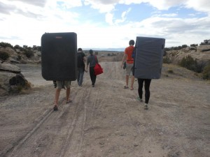 Climbers walk with bouldering pads