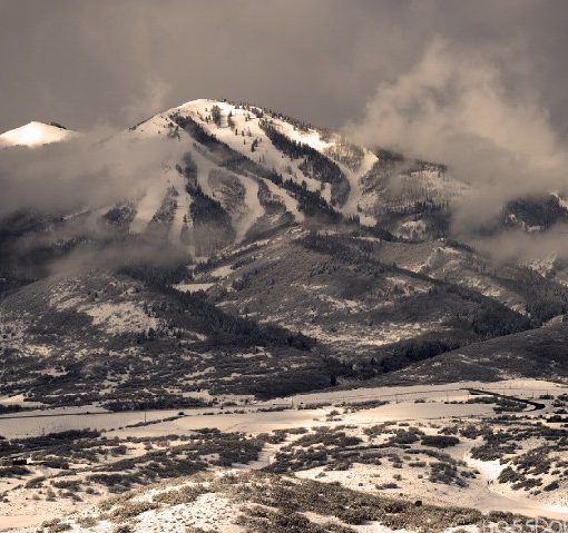 low clouds fram snowy mountain resort on a grey day