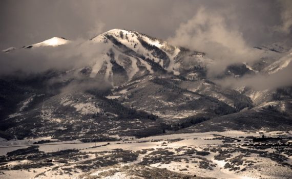 low clouds fram snowy mountain resort on a grey day