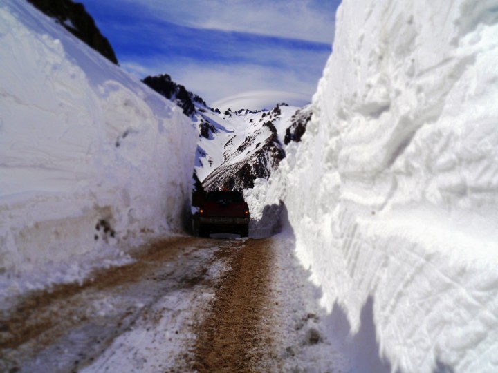 a truck with huge piles of snow on each side