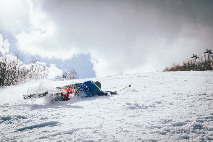 Skier falling down the slopes
