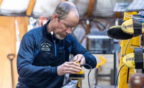 Ski technician preps Nordic ski for summer storage