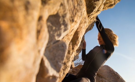 Side view of woman bouldering