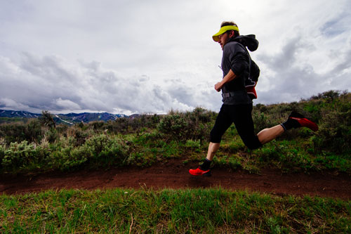 A runner jogs on a trail