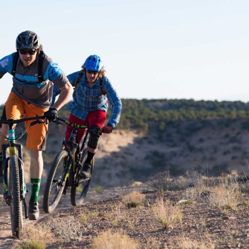 Two mountain bikers riding the Good Water Rim trail in southern Utah