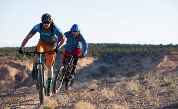 Two mountain bikers riding the Good Water Rim trail in southern Utah