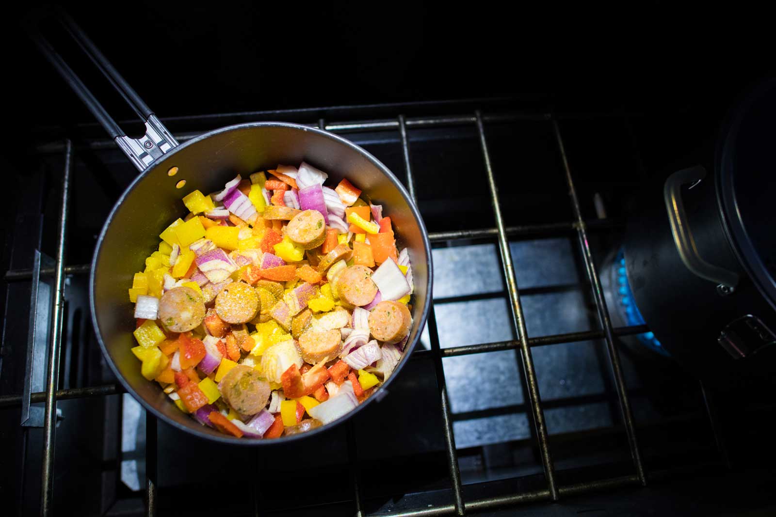 A camp meal being cooked on a stove in the Utah desert