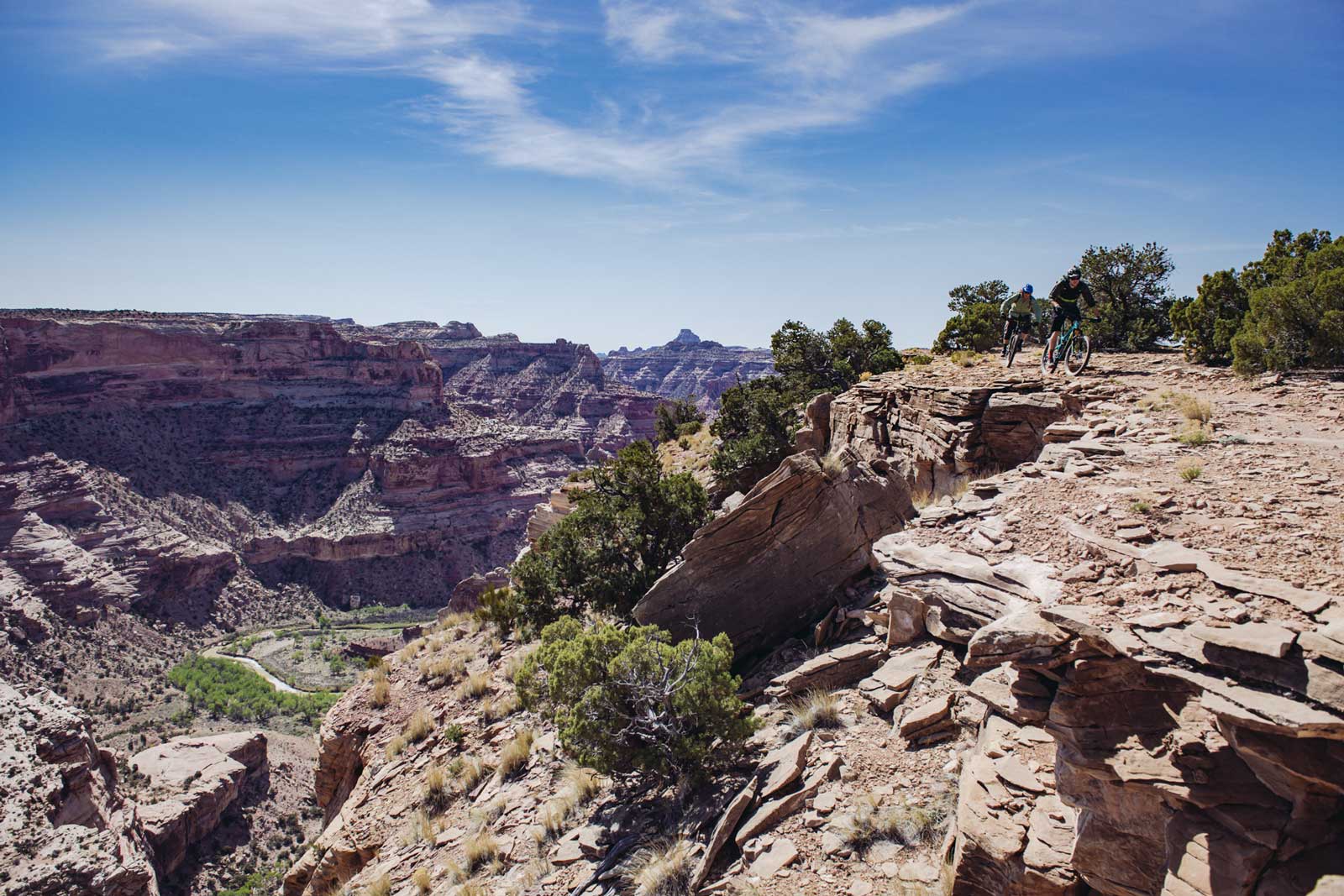 Two mountain bikers on the Good Water Rim trail overlooking the San Rafael Swell