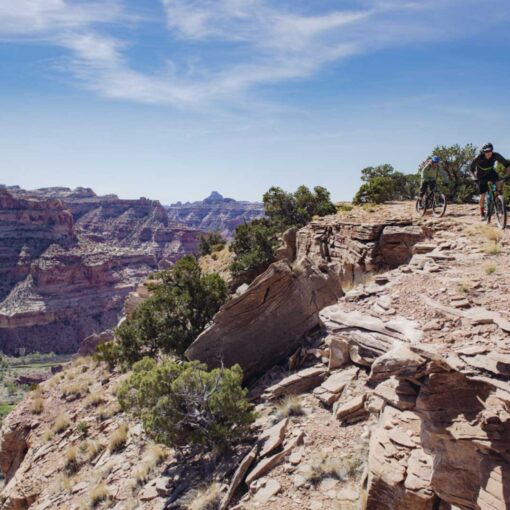 Two mountain bikers on the Good Water Rim trail overlooking the San Rafael Swell