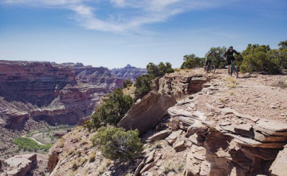Two mountain bikers on the Good Water Rim trail overlooking the San Rafael Swell