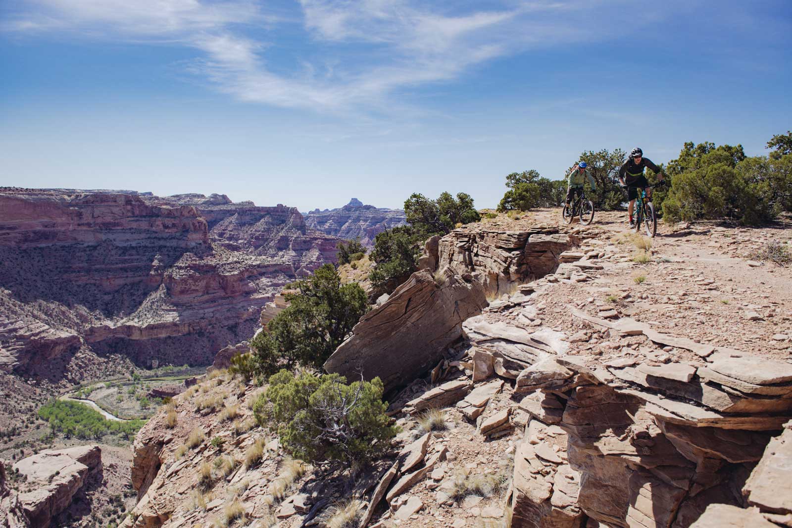 Two mountain bikers on the Good Water Rim trail overlooking the San Rafael Swell