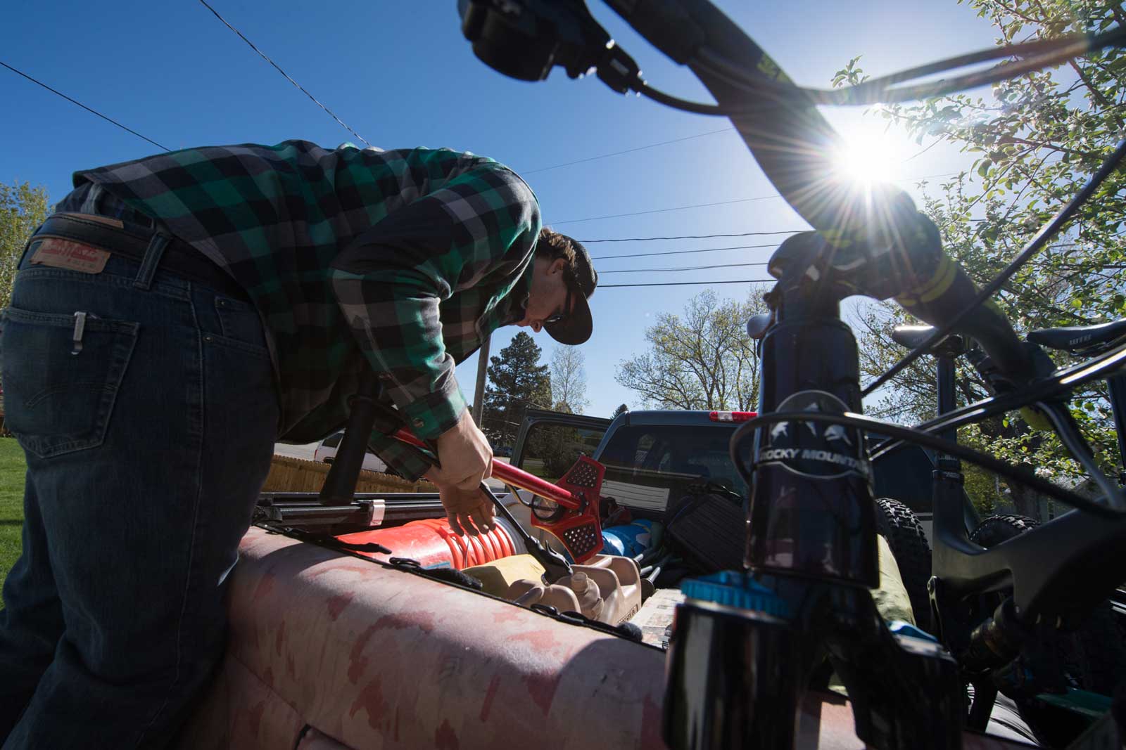 A man packs a truck with camp and bike gear for a trip to the Utah desert