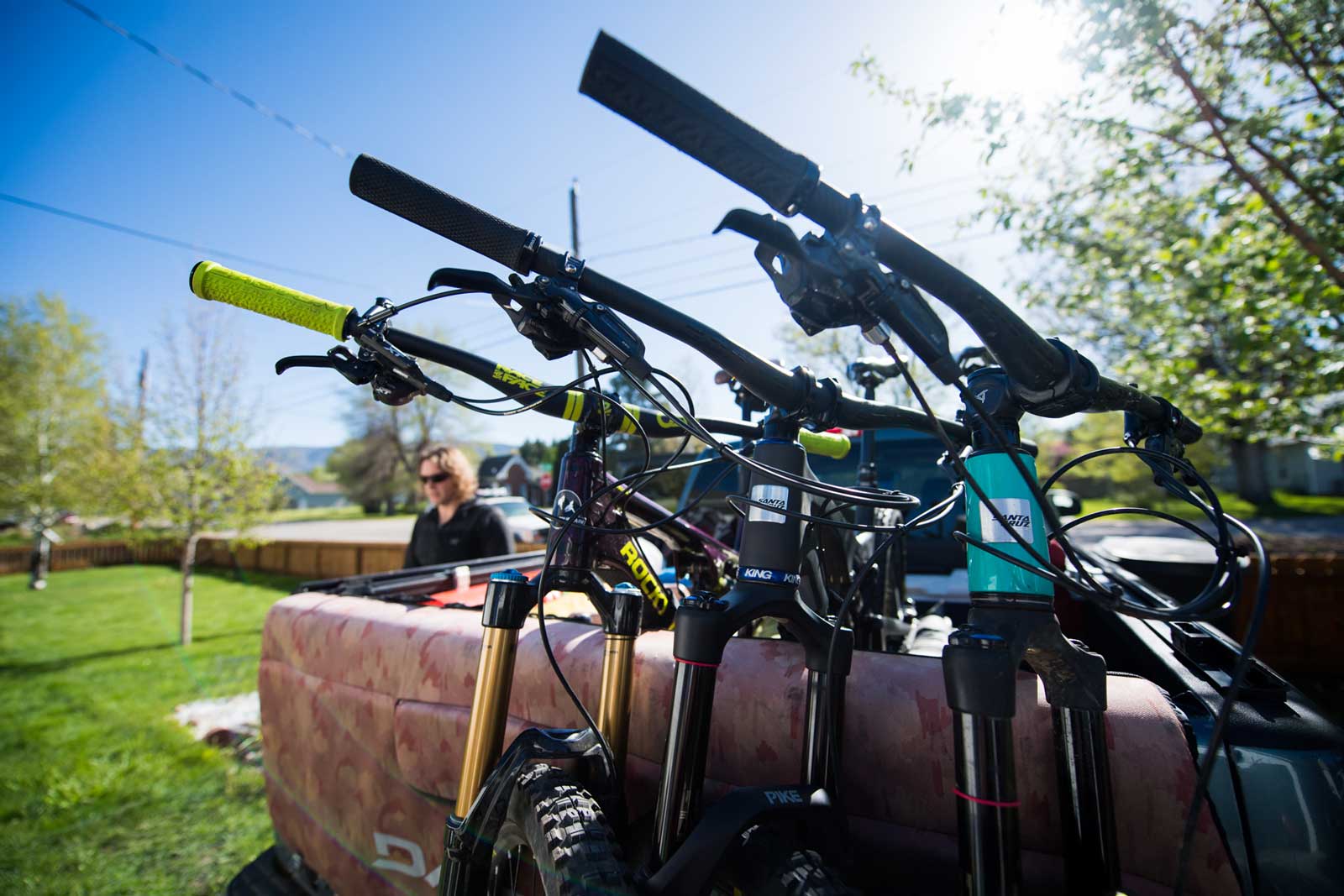 Three bikes and other camping gear in a truck bed
