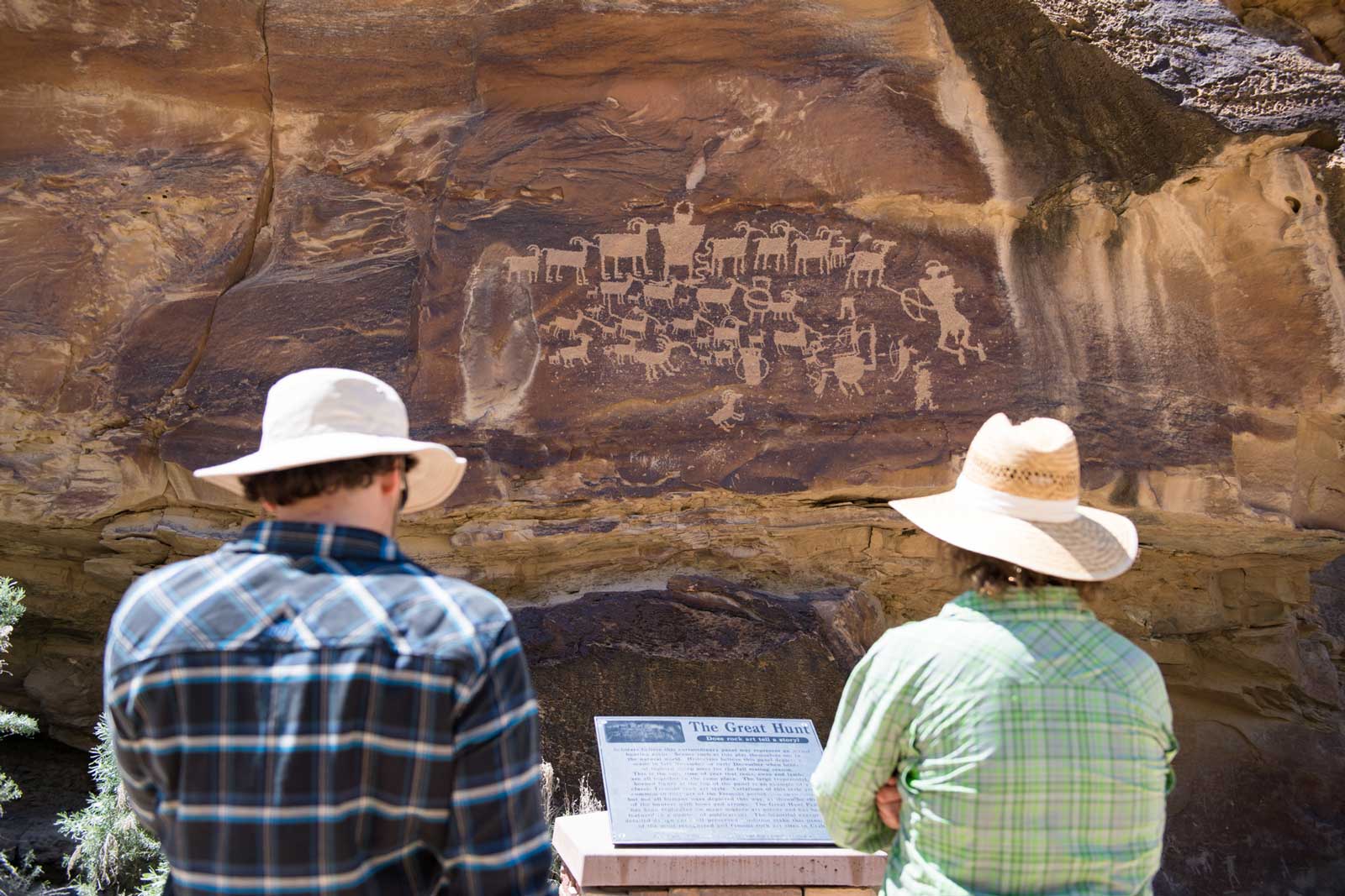 Two men view Native American petroglyphs in the Utah desert