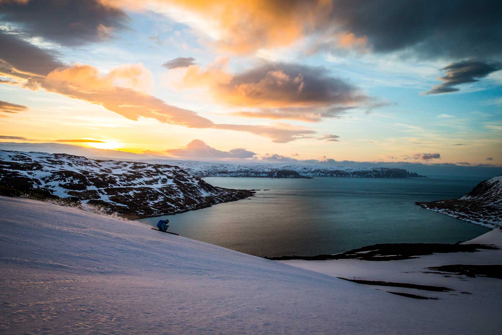 Skier Descends slope at dusk