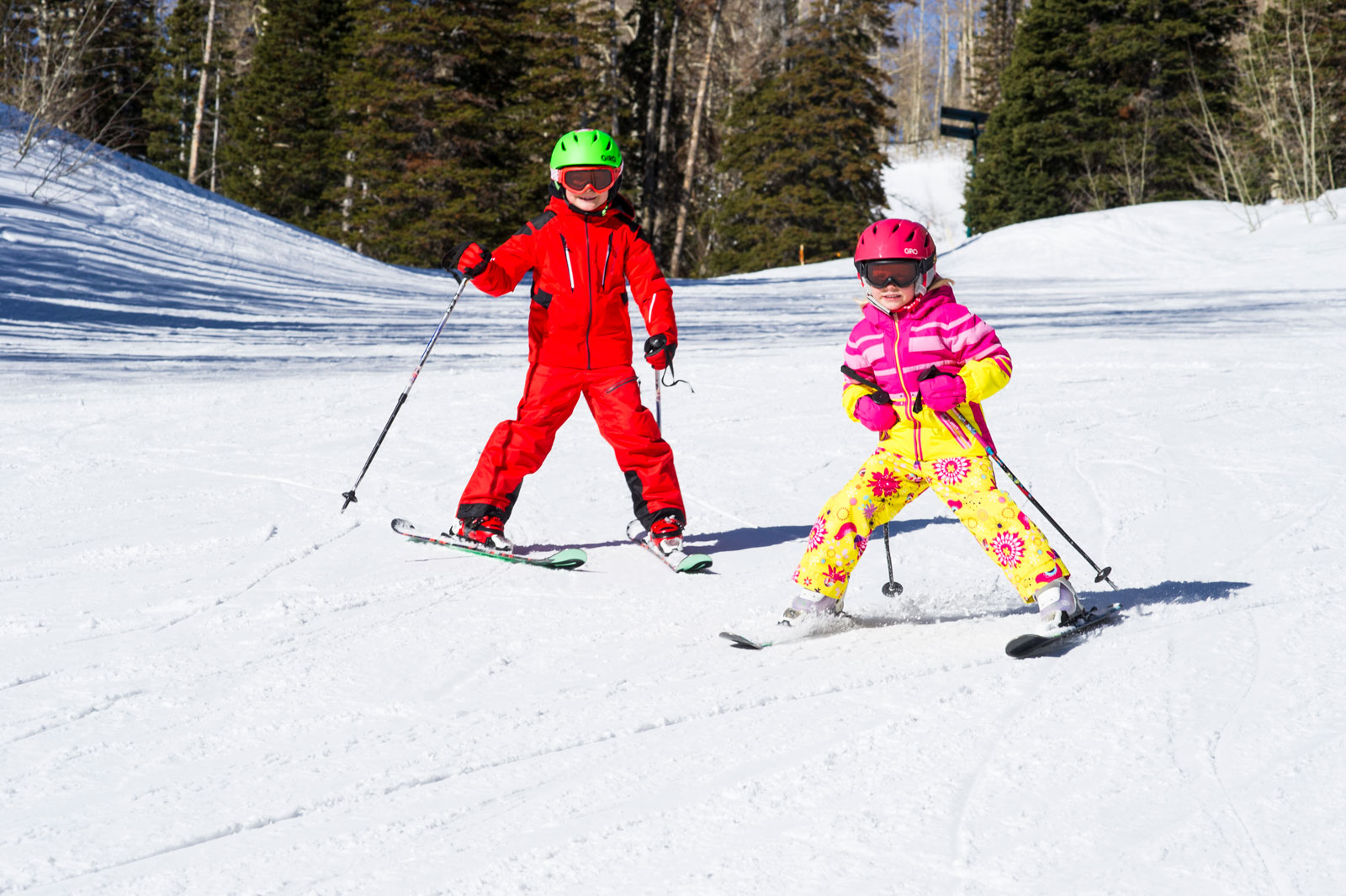 Kids skiing at Deer Valley Resort wearing ski helmets