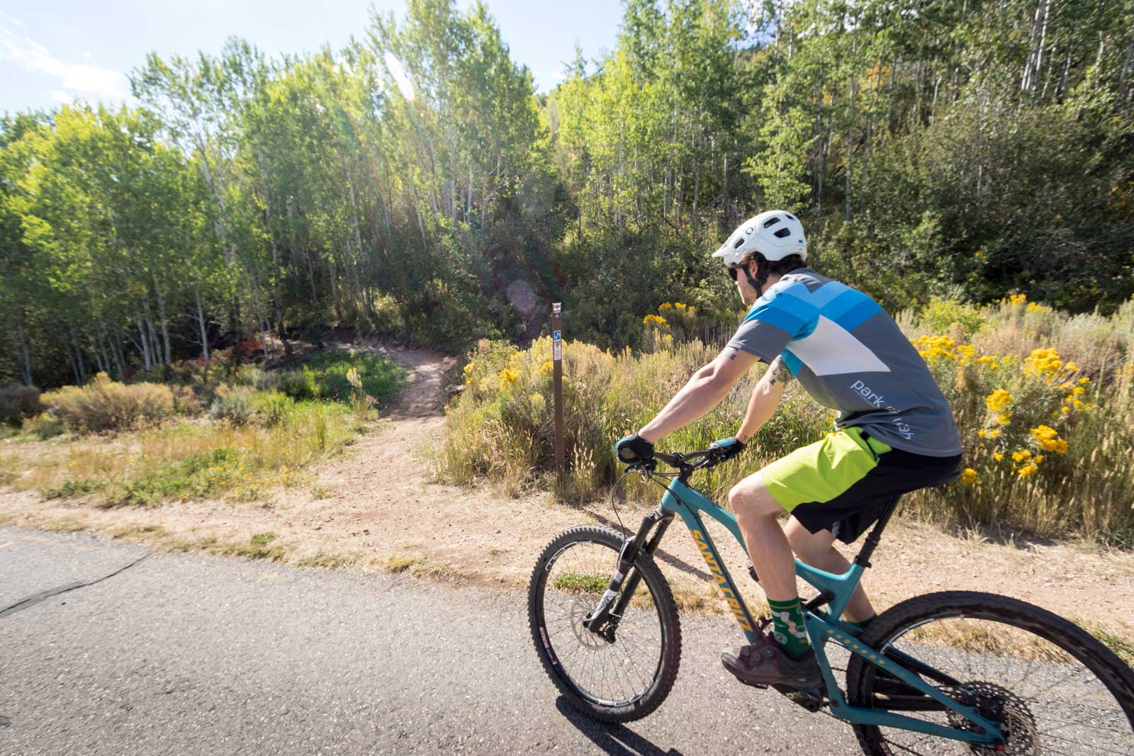 A mountain biker turning off the Rail Trail onto the Freemason Trail in Park City, UT