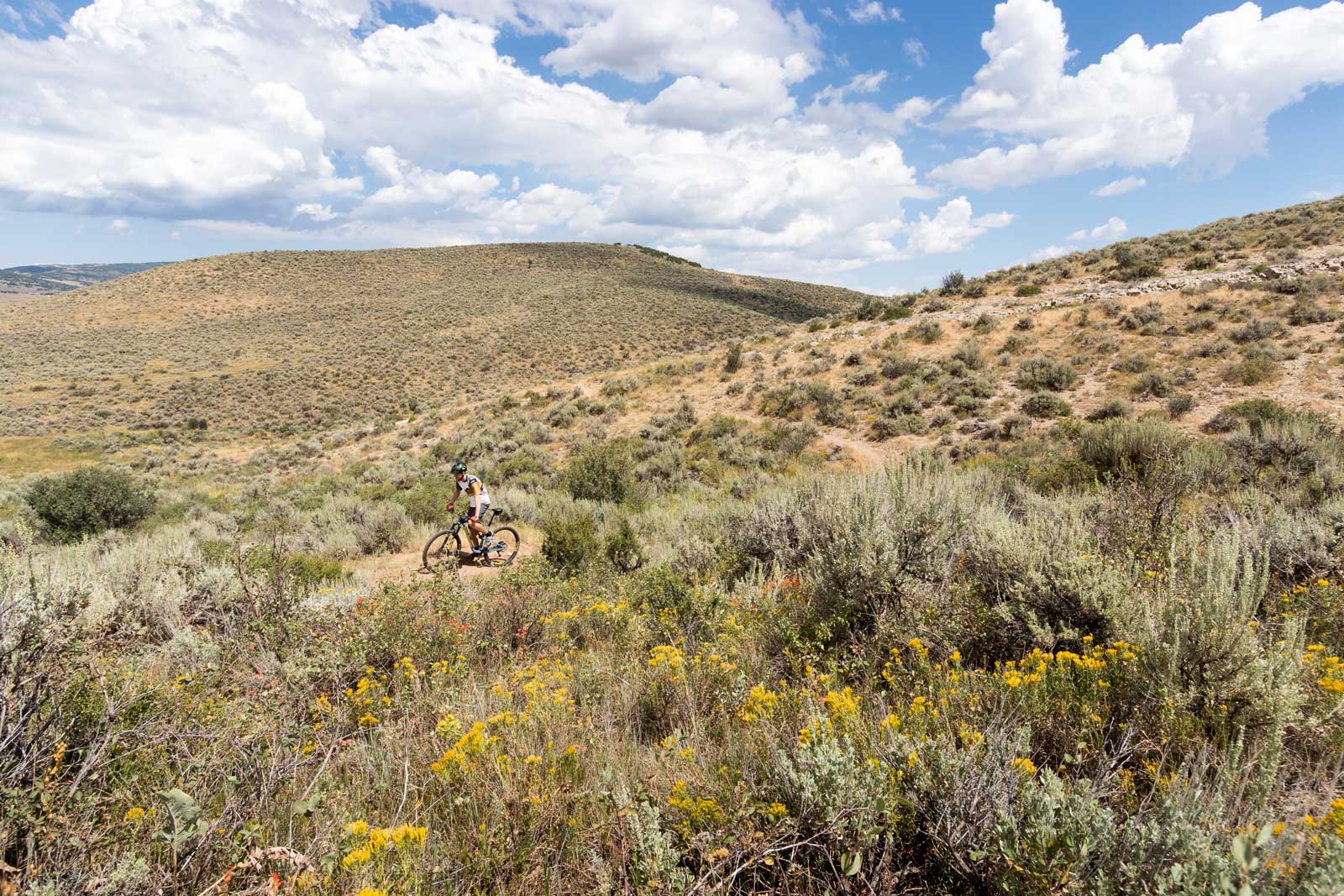A mountain biker riding the Happy Gilmor trail in Park City, UT