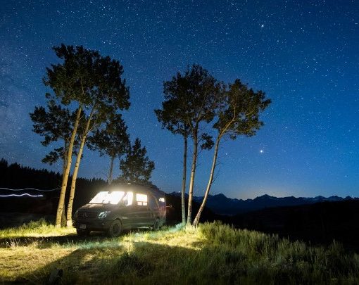 Stars come out over a van parked under trees