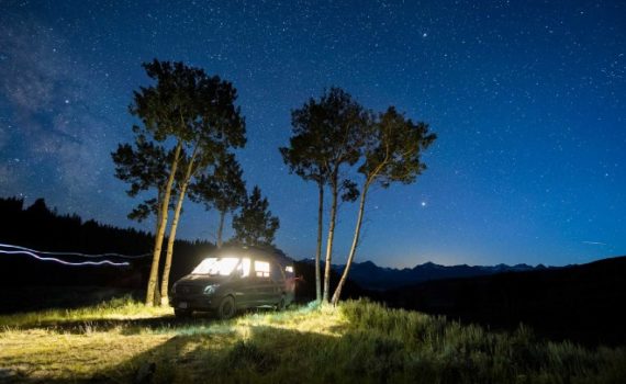 Stars come out over a van parked under trees