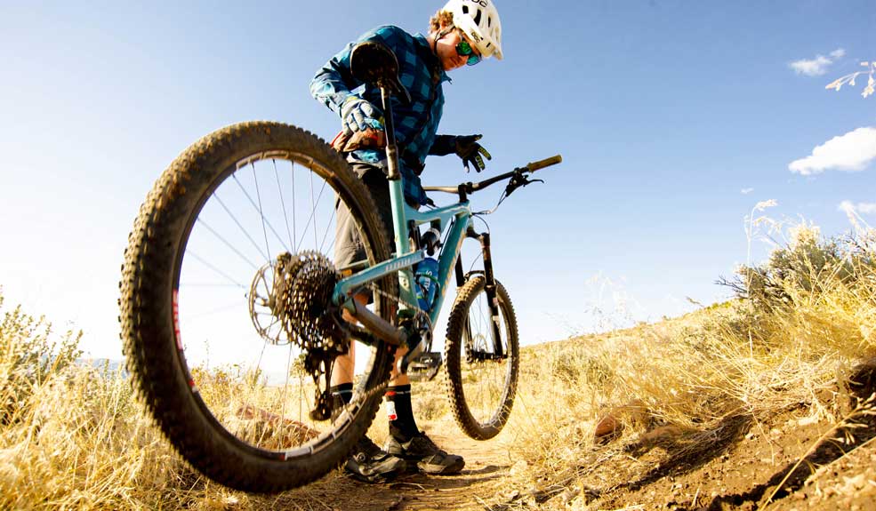 Mountain biker giving his bike a drop test after a crash