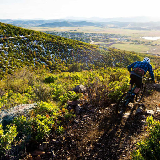 A rider goes down a trail at High Star Ranch