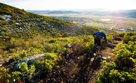 A rider goes down a trail at High Star Ranch