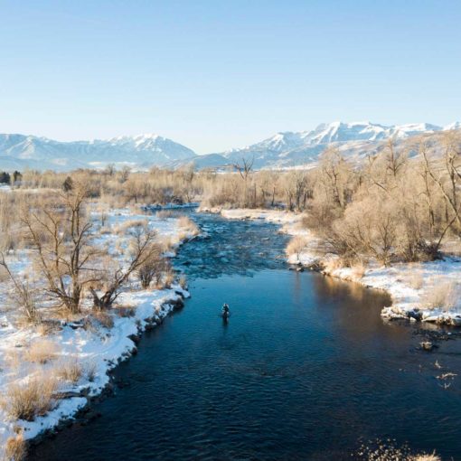 Skyview of fisherman casting in a river