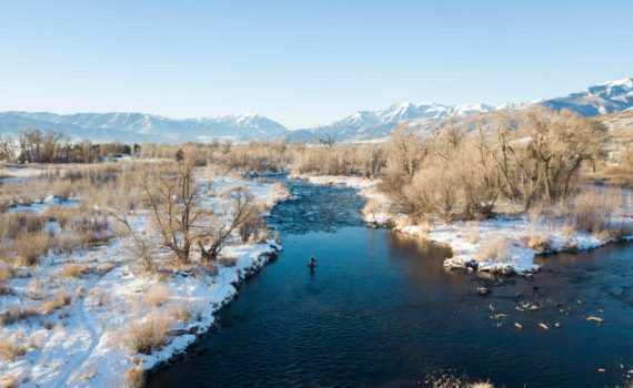 Skyview of fisherman casting in a river