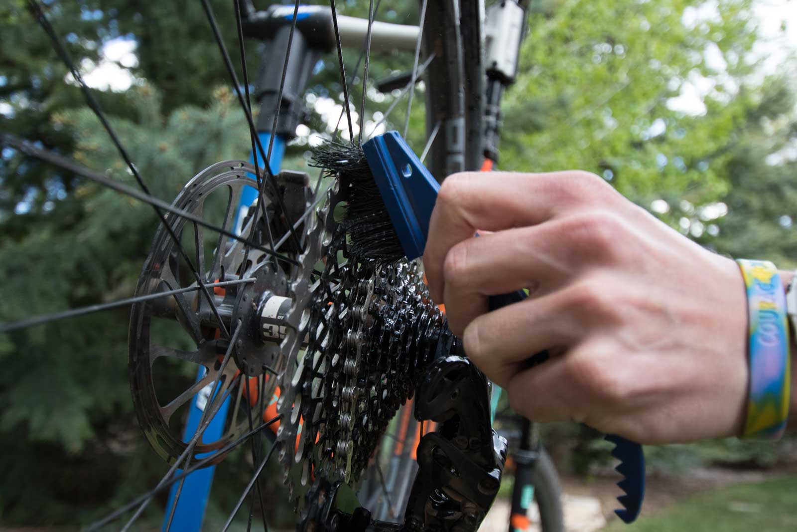 Cleaning a bike cassette with a bristle brush