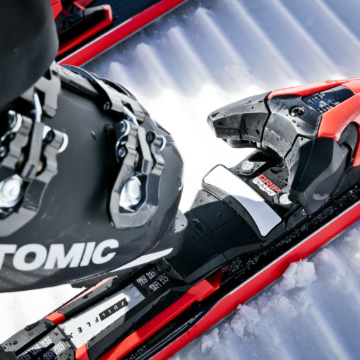 Atomic ski boot clipping into a ski binding