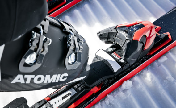 Atomic ski boot clipping into a ski binding