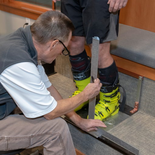 Jans Expert bootfitter, Paul Archer, fitting boots at Rennstall Ski Tech Center in Park City, Utah.