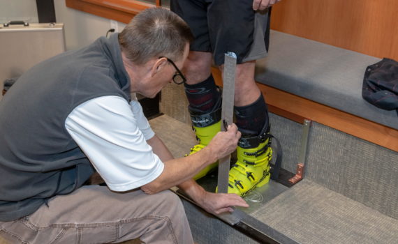 Jans Expert bootfitter, Paul Archer, fitting boots at Rennstall Ski Tech Center in Park City, Utah.