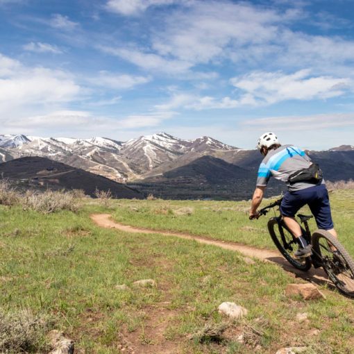 A mountain biker riding singletrack in Round Valley, Park City, UT