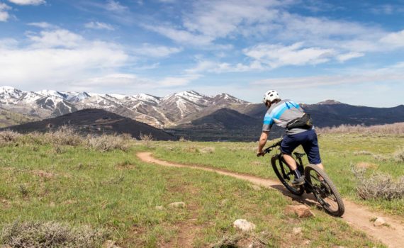 A mountain biker riding singletrack in Round Valley, Park City, UT