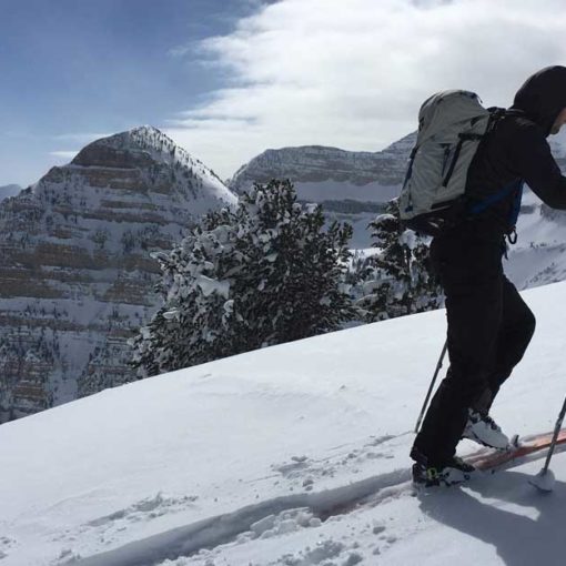 Skier ascends ridge with Mount Timpanogos in the background