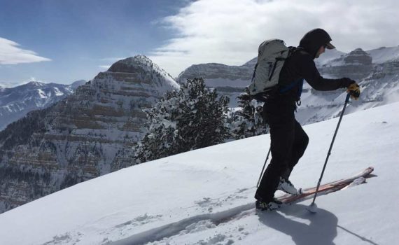 Skier ascends ridge with Mount Timpanogos in the background