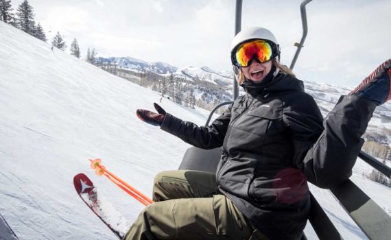 Jans employee rides ski lift with friend at Deer Valley.
