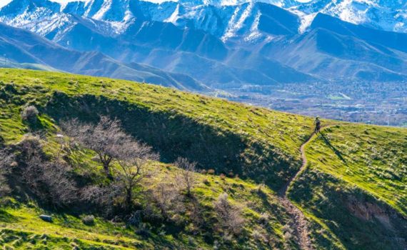 a lone mountain biker descends a trail in north salt lake