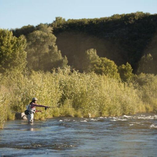 A Jans employee wades into the provo river while fly fishing.