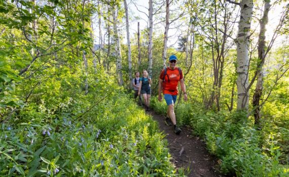White Pine Touring guide leads a group on a hiking tour in Park City, UT.