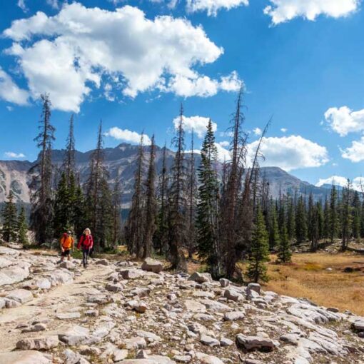 Two hikers head towards Ruth Lake in the Uinta Mountains.