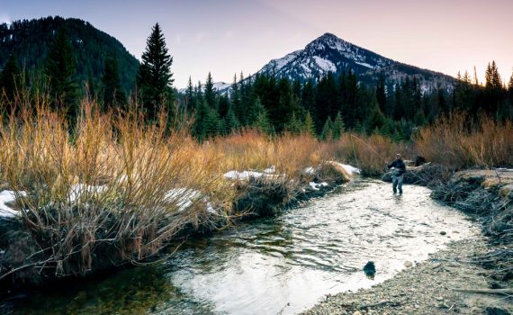Jans employee Jeff Sorenson fly fishes on a creek in fall.
