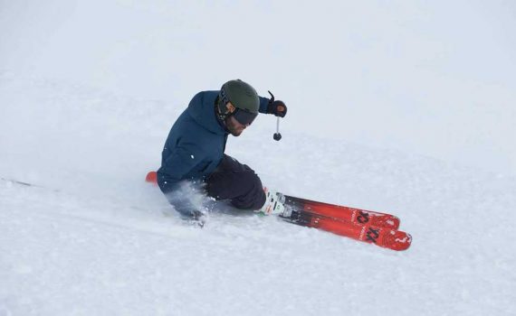 A skier carves a turn on the Volkl M6 Mantra.