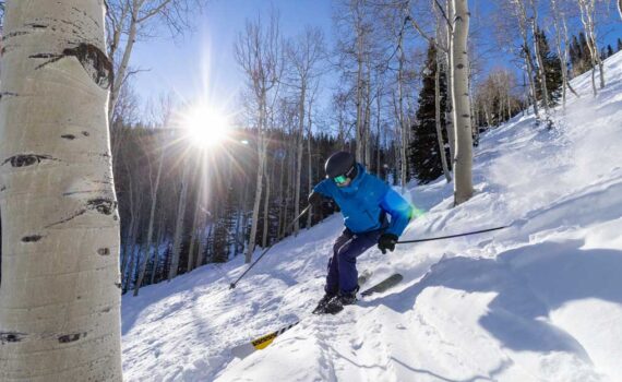 Alpine skier skis through aspens at Deer Valley Resort in Park City, UT