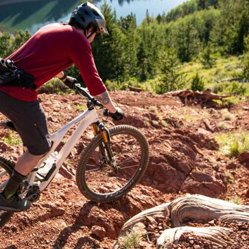 A mountain biker descends a chute on The Spine in Park City, UT