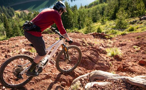 A mountain biker descends a chute on The Spine in Park City, UT