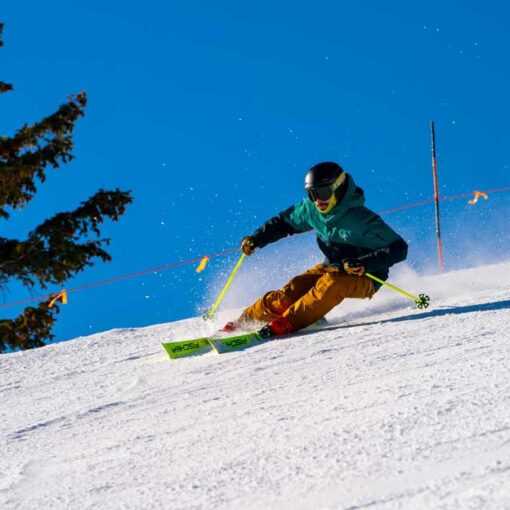 A skier carves a turn on a groomed run at Deer Valley, Park City, UT